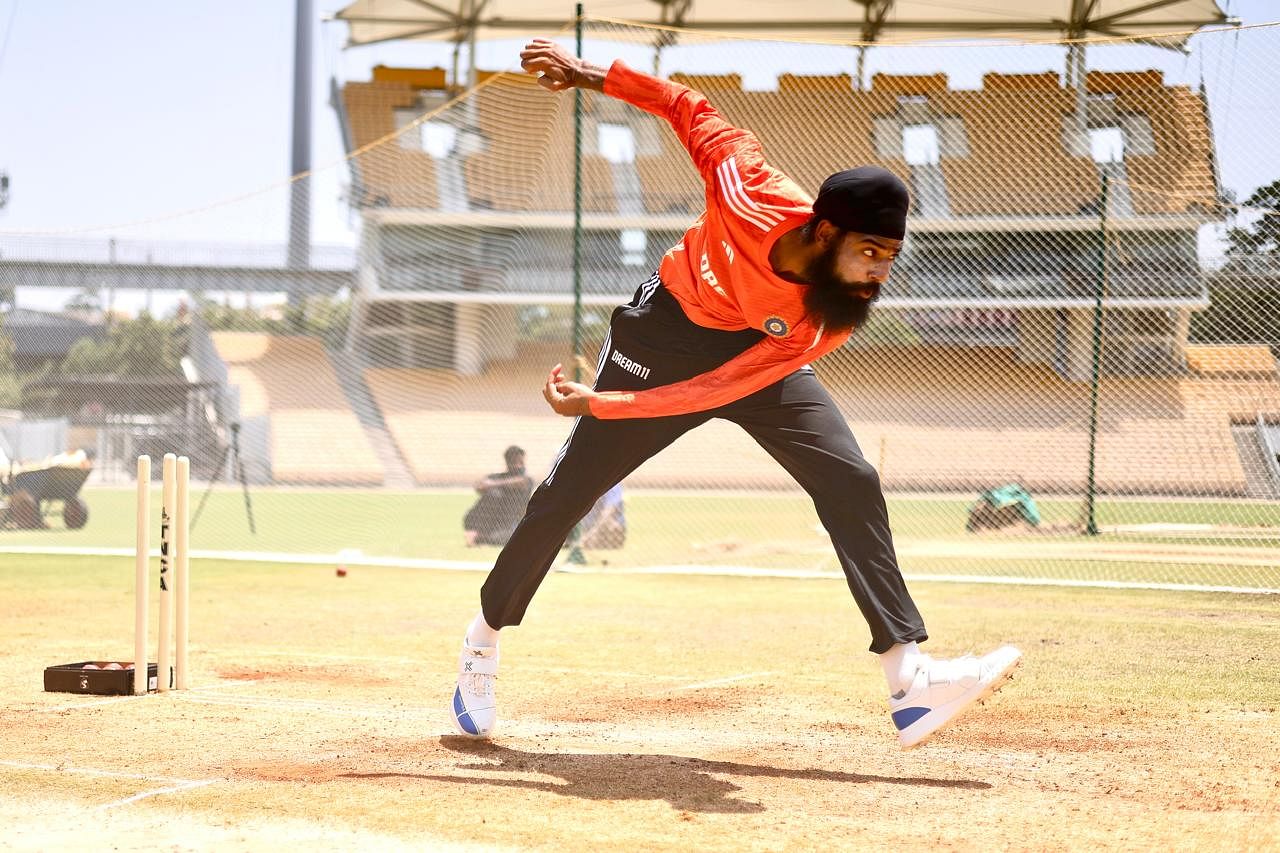 Ambala's Gurjapaneet discussing bowling with Virat Kohli during net practice.