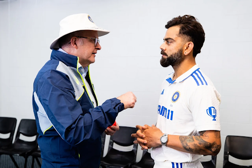 Australian Prime Minister talking to Indian cricketer Virat Kohli.